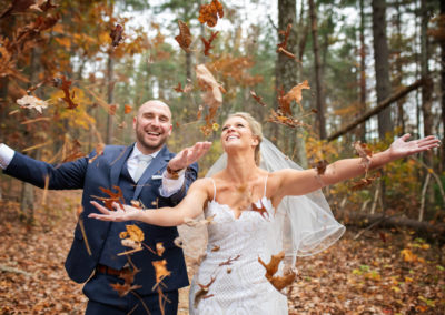 bride and groom throwing leafs