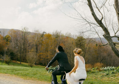 bride and groom riding bikes